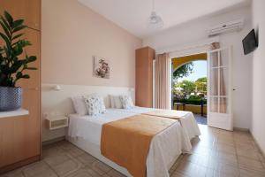 a bedroom with a bed and a large window at Tereza Apartments in Acharavi +59 photos