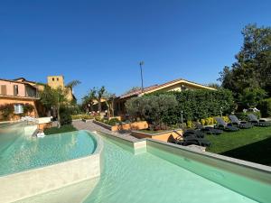 a swimming pool in a house with chairs in a yard at Antica Locanda Palmieri in Rome