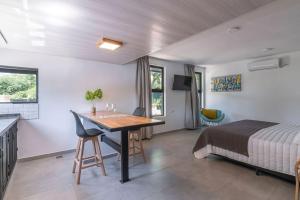 a bedroom with a bed and a table in a room at Laurentino Loft & Home in Villa General Belgrano