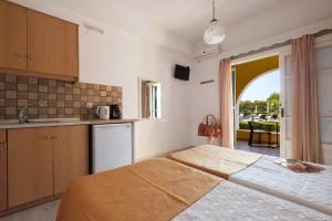 a kitchen with a large bed in a room at Tereza Apartments in Acharavi