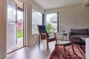 a living room with a chair and a couch at Perfekt base for det meste! in Leknes