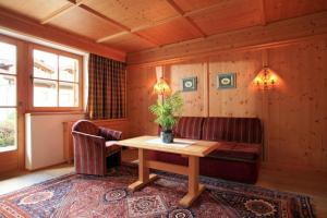 a living room with a table and a couch at Appartement Riedl Martin in Brixen im Thale
