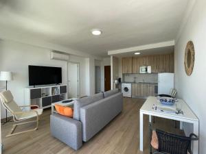 a living room with a couch and a table at Concordia in Roquetas de Mar