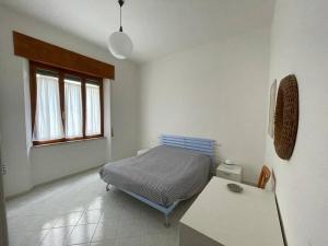 a bedroom with a bed and a table in it at Nuova ristrutturazione a due passi dal Mare in Castiglione della Pescaia