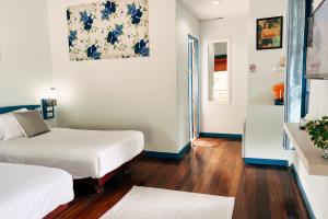 a hotel room with two beds and a hallway at Cruiser Island By Swiss-Belhotel in Ko Lone