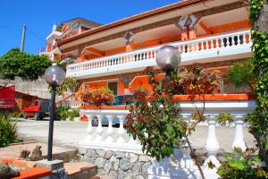 an orange and white building with a white fence at Villa delle Muse da Imma in Palinuro