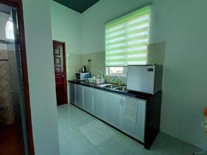a kitchen with a sink and a counter top at Aja Retreat Chalet in Jitra