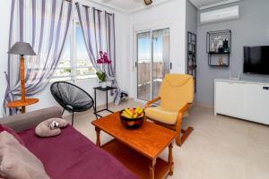 a living room with a couch and a table at San Sebastián 22 in Torrevieja