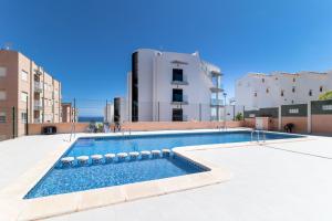 a swimming pool on the side of a building at San Sebastián 22 in Torrevieja