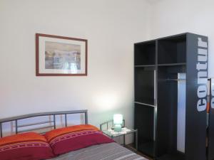 a bedroom with a bed and a black book shelf at CAPTAIN'S Holiday HOUSE in Žirje