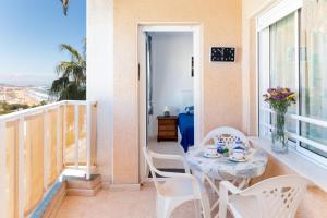 a room with a table and chairs and a balcony at San Sebastián 22 in Torrevieja