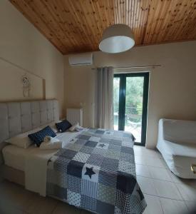 a bedroom with a bed with a checkered blanket at Rozos House in Loutsa