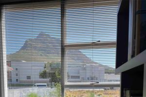 a view of a large building through a window at Mountain View flat in Cape Town