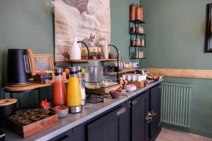 a kitchen with a counter with a counter top with food at Hôtel Le Patio - Deauville in Deauville
