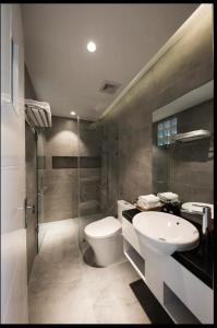 a bathroom with a toilet and a sink and a shower at Green Peace Village in Da Nang