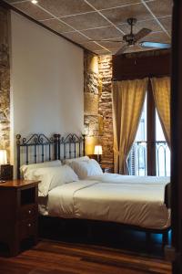 a bedroom with two beds and a window at San Sebastián DOT Rooms in San Sebastián