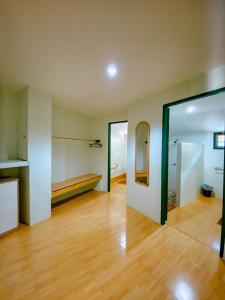 an empty room with a wooden floor and two sliding doors at Cruiser Island By Swiss-Belhotel in Ko Lone