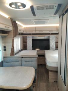 an interior of an rv with two beds and a table at Achziv Beach אכזיב חף in Liman