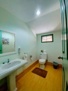 a bathroom with a sink and a toilet at Cruiser Island By Swiss-Belhotel in Ko Lone