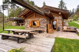 a log cabin with a picnic table in front of it at Chalet alla Perla, Grumes in Grumes
