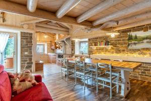 a kitchen with a table and chairs and a stone wall at Chalet alla Perla, Grumes in Grumes