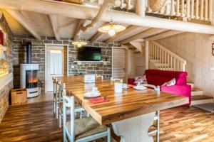 a dining room with a wooden table and a fireplace at Chalet alla Perla, Grumes in Grumes