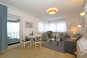 a living room with a couch and a table at Fischer in Westerland