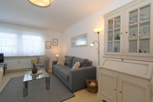 a living room with a couch and a table at Fischer in Westerland