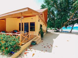 a small house with a porch on the beach at Cruiser Island By Swiss-Belhotel in Ko Lone