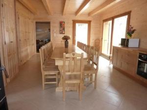 a dining room with a wooden table and chairs at Chalet Bellevue in Les Orres
