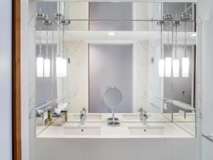 a bathroom with three sinks and a mirror at 33 Seaport Hotel New York in New York