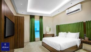 Ένα ή περισσότερα κρεβάτια σε δωμάτιο στο فندق سكناي الياسمين