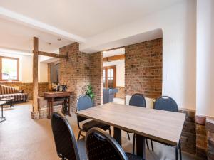 a dining room with a wooden table and chairs at Holiday home with sauna in the Eifel National Park in Schleiden +29 photos