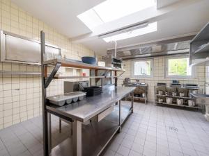 a large kitchen with a counter in a kitchen at Holiday home with sauna in the Eifel National Park in Schleiden