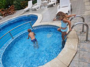 a boy and a girl playing in a swimming pool at M-amadeus in Sunny Beach