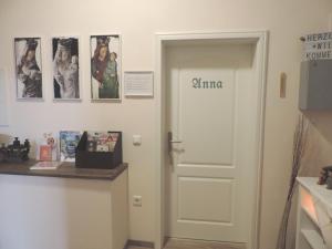a white door with the word mimosa written on it at Altstadtidylle Allerheiligen in Erfurt