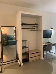 a bedroom with a bunk bed and a desk and a mirror at E2G URBAN STAY with Balcony in Thessaloniki