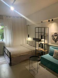 a bedroom with two beds and a table and a couch at E2G URBAN STAY with Balcony in Thessaloniki
