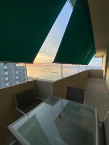 a glass table and chairs in a room with a view at Tramonto in Baia in Pesaro +90 photos