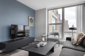 a living room with a couch and a tv at Edgewater 1br w gym deck lounge nr L CHI-918 in Chicago