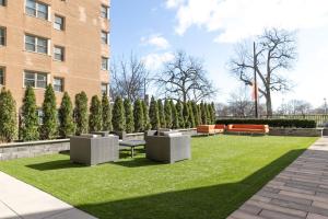 a park with benches and grass in front of a building at Edgewater 1br w gym deck lounge nr L CHI-918 in Chicago