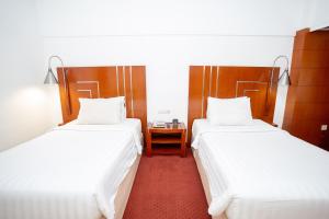 Postel nebo postele na pokoji v ubytování Hotel Savoy Homann