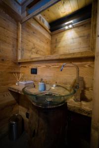 a bathroom with a sink in a wooden room at Appartamento NeveSole in San Vito di Cadore