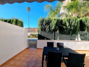 a dining room with a table and chairs on a patio at Cal Marc - Piso con piscina y terraza in Ulldecona
