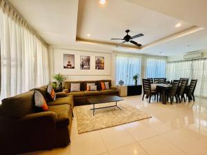 a living room with a couch and a dining room at Country club townhouse in Bang Tao Beach