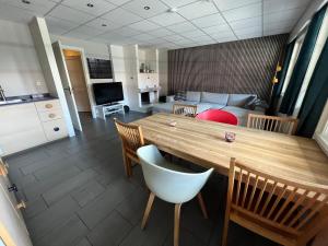 a kitchen and living room with a wooden table and chairs at Spacious 2-bedroom holiday apartment - Hemsedal Veslehorn 14 in Hemsedal