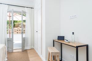 a bedroom with a door leading to a patio at Boutique Hotel Oriola in Cala de Sant Vicenc +37 photos