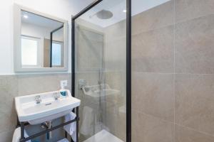 a bathroom with a sink and a shower stall at Boutique Hotel Oriola in Cala de Sant Vicenc