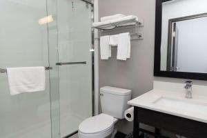 a bathroom with a shower and a toilet and a sink at Motel 6 Fort Worth TX Lake Worth in Fort Worth