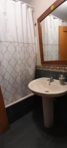 ein Bad mit einem Waschbecken und einem Spiegel in der Unterkunft APARTAMENTO GRETA in Torrenueva